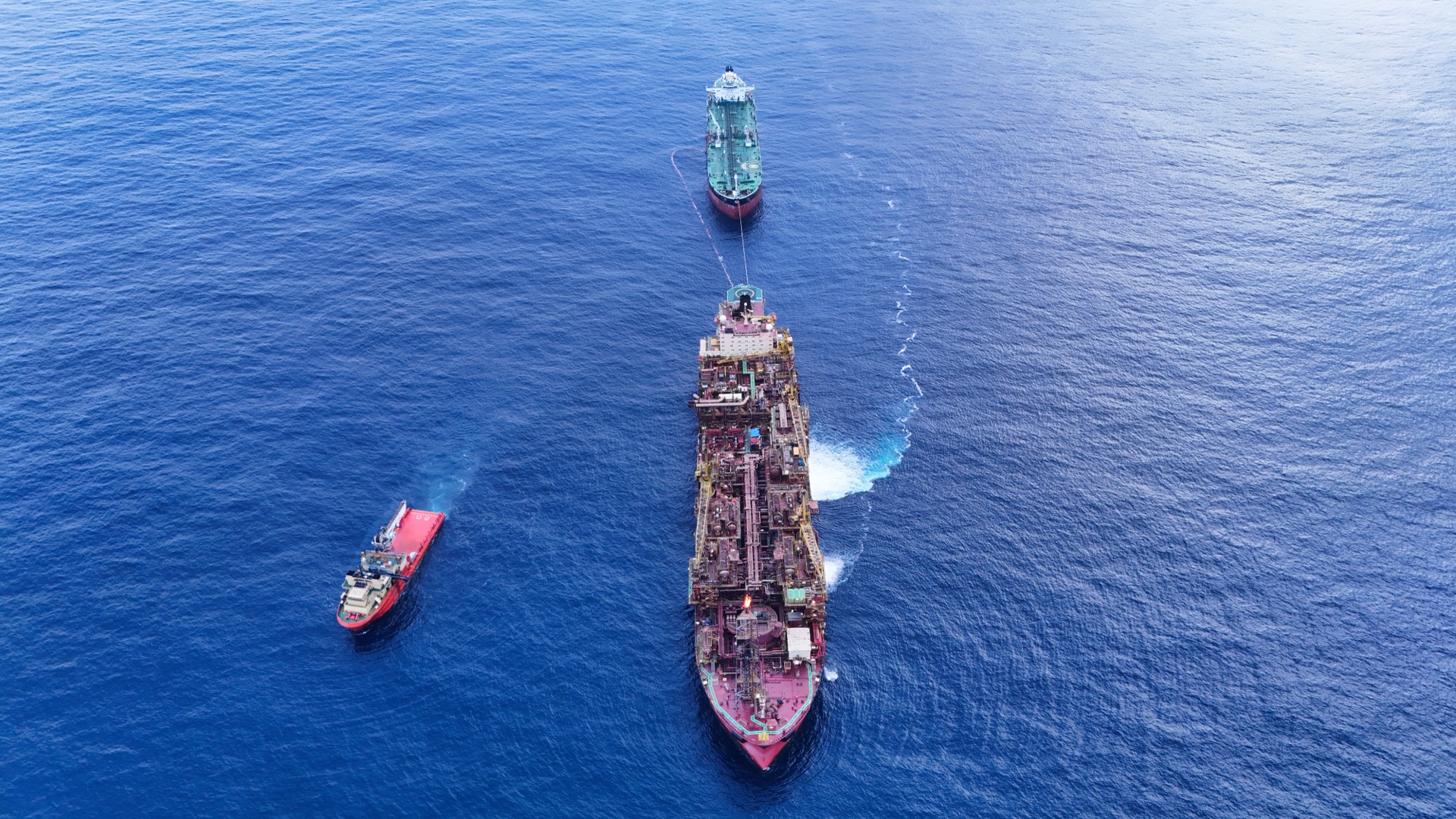 Aerial view of FPSO tandem offloading with AHTS in attendance, Campos Basin